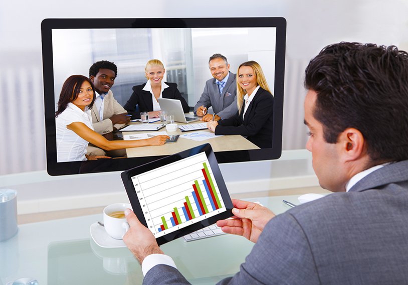 Young Businessman Analyzing Graph While Chatting With His Colleagues