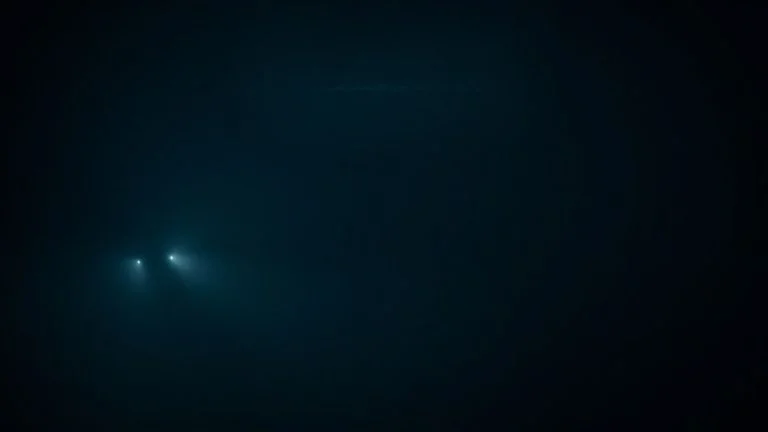 Submarine silhouette beneath a shimmering, distorted ocean surface.
