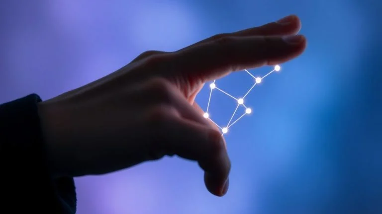 Human hand interacting with glowing AI.