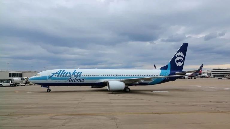 Alaska Airlines plane grounded at airport due to IT issue.