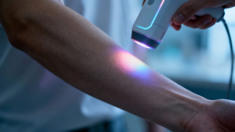 Light-based glucose monitor on arm, no needle.