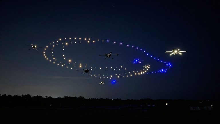 AI drones create a dazzling aerial light show at night.