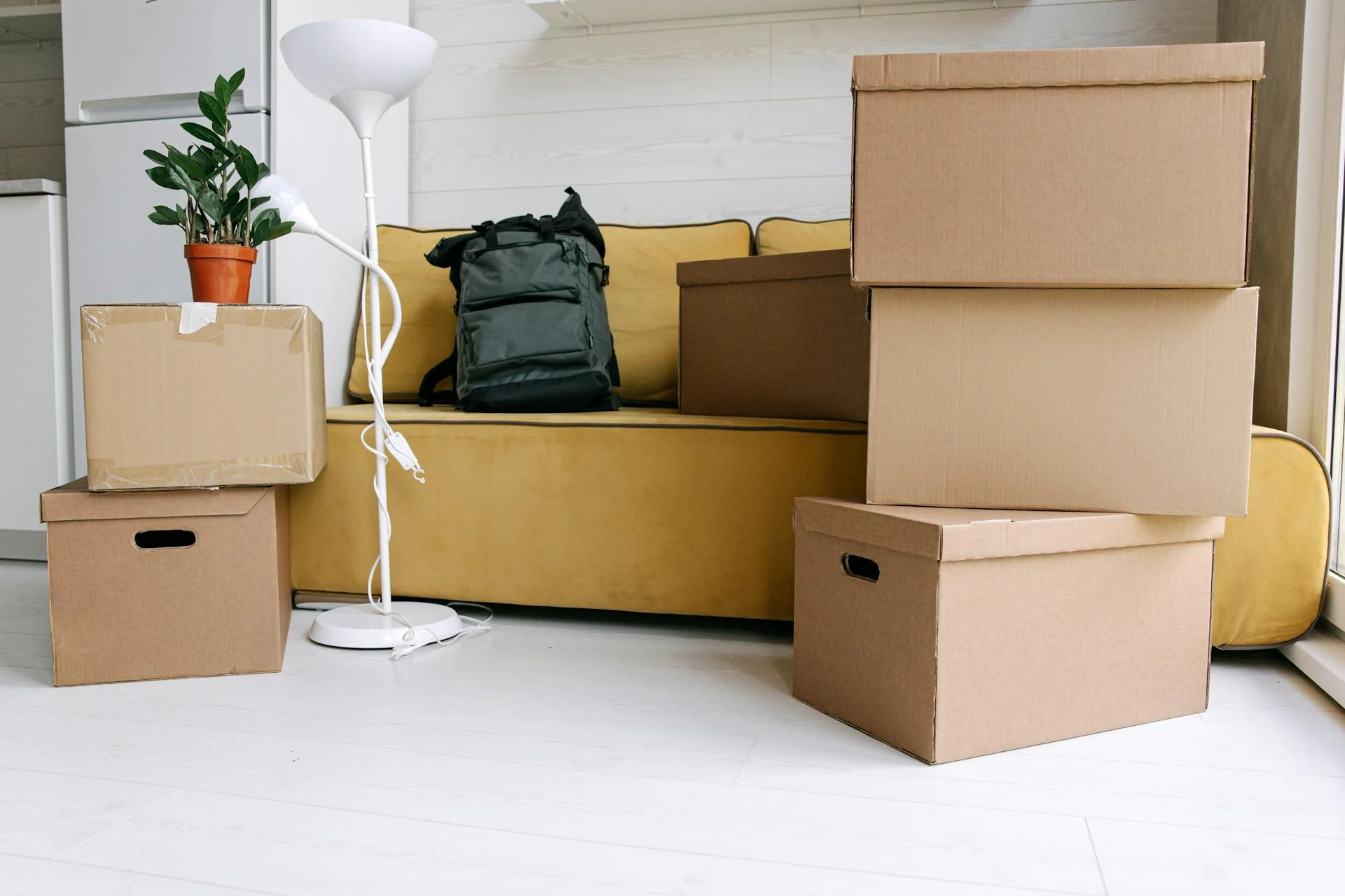 Corporate office during relocation with moving boxes stacked in an empty conference room