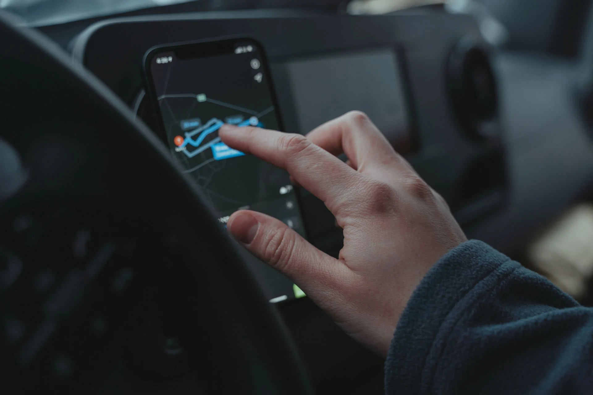 A driver using a car insurance app on a phone